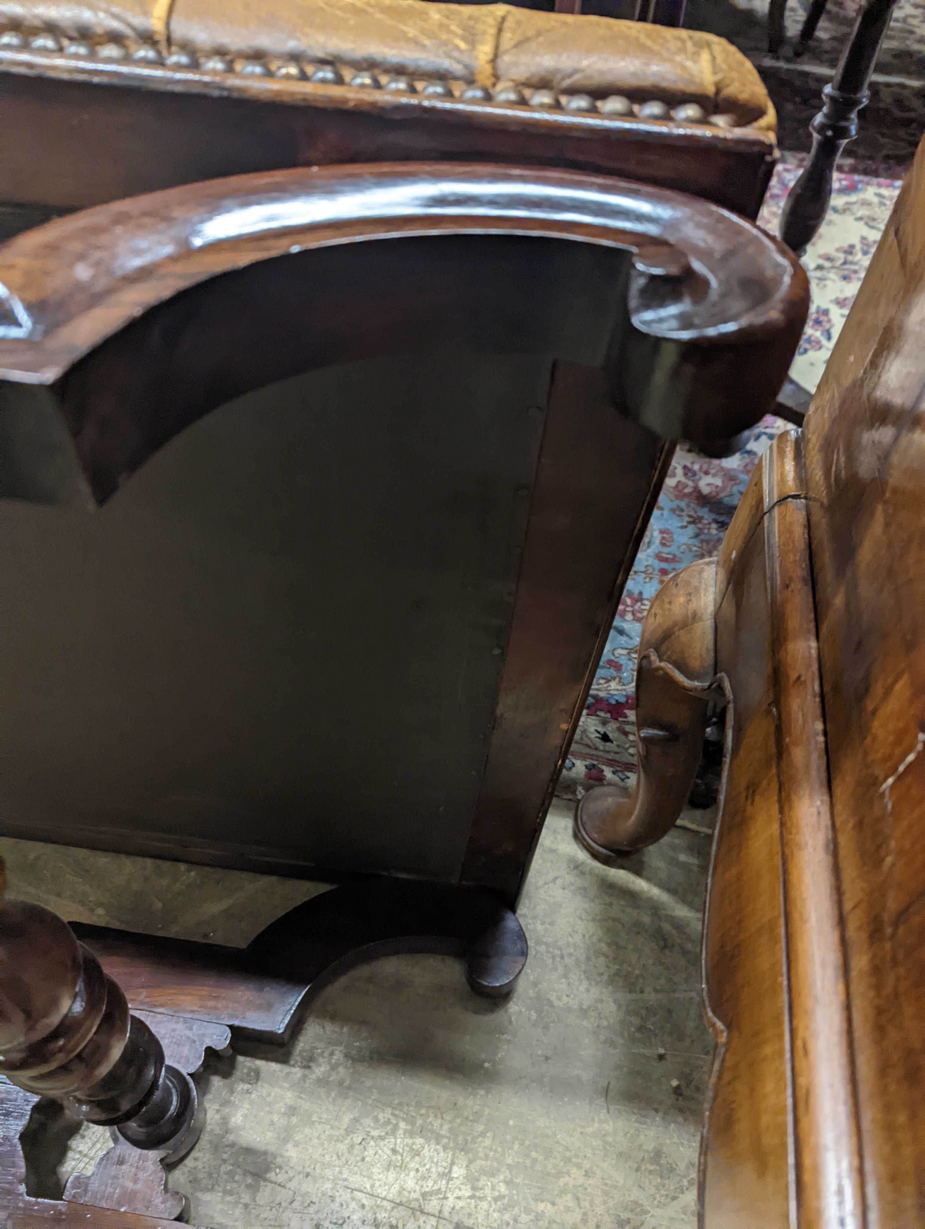 A Victorian carved X-framed rosewood footstool, upholstered in a buttoned brown leather, width 90cm depth 57cm height 42cm